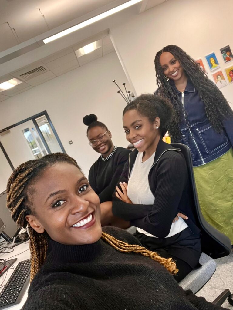 Four Black women posing for a selfie