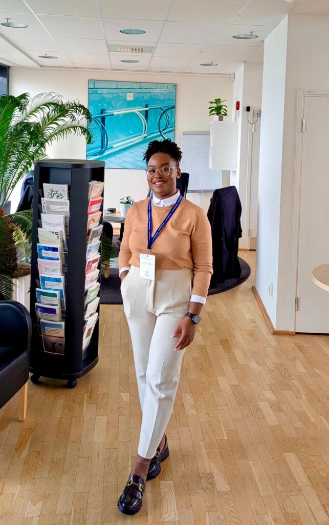 A Black woman wearing a lanyard.