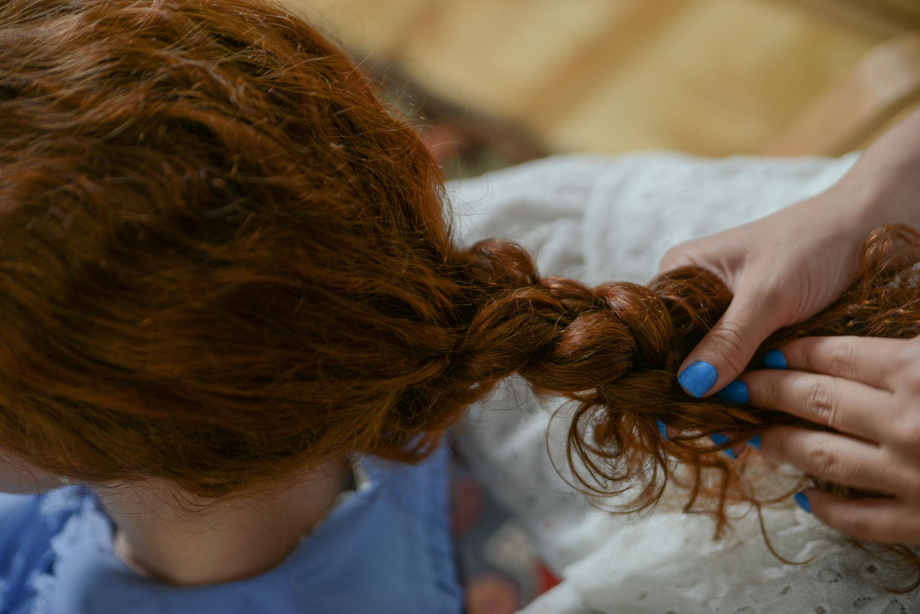 hands braiding a woman s hair