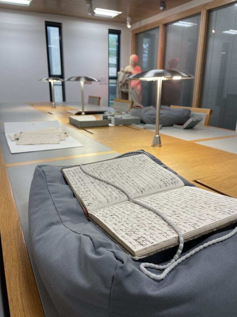The Reading Room in the Cadbury Research Library, with a manuscript on a book cushion held open by a snake weight.